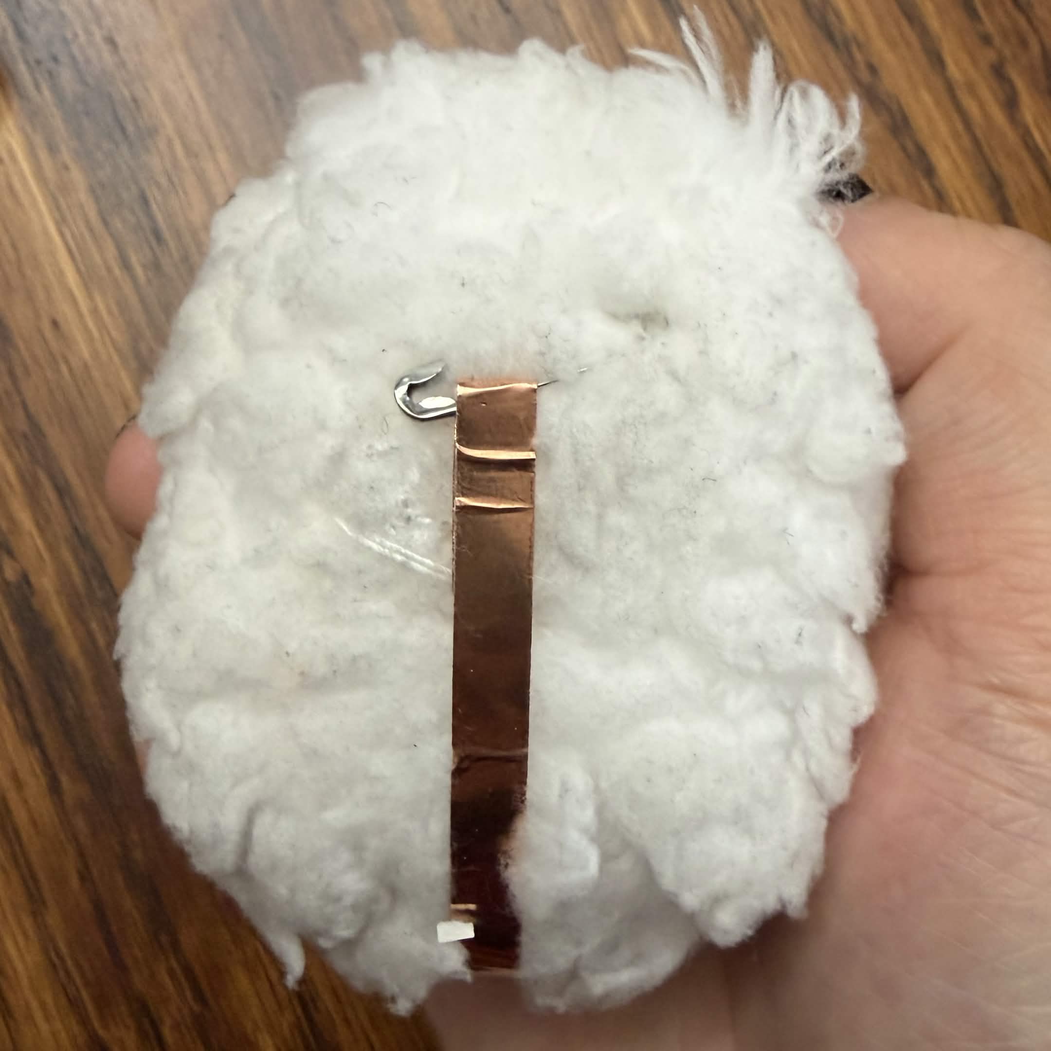 Underside view of fluff ball prototype. The conductive tape is added for Makey Makey contact.